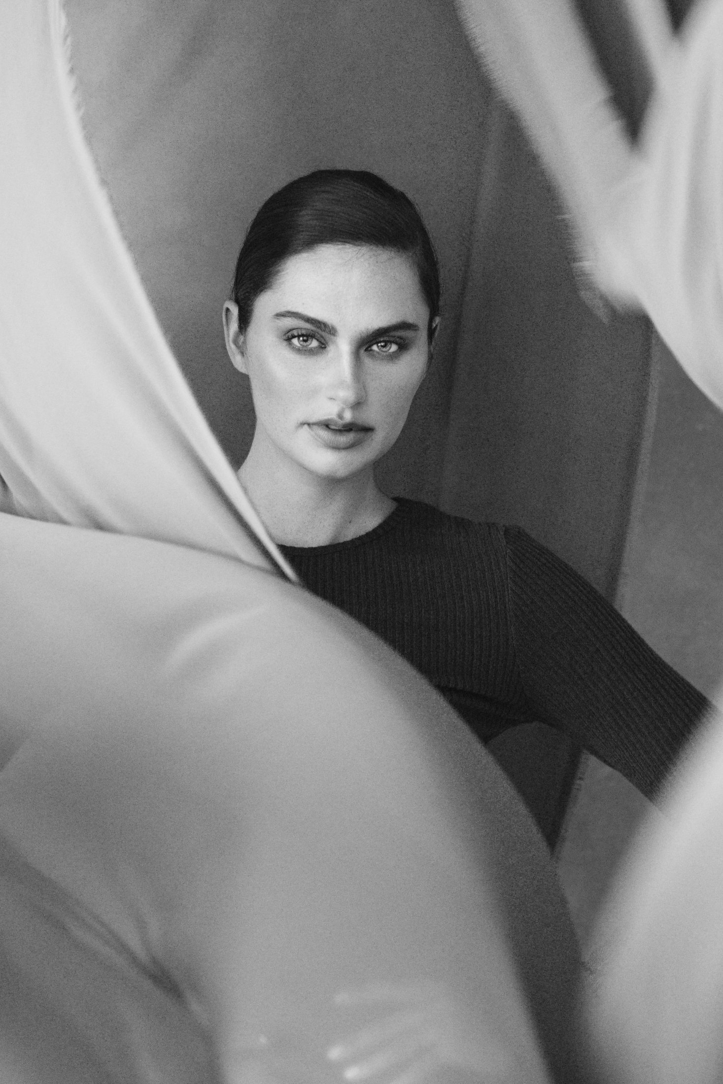 Black and white portrait through sheer fabric
