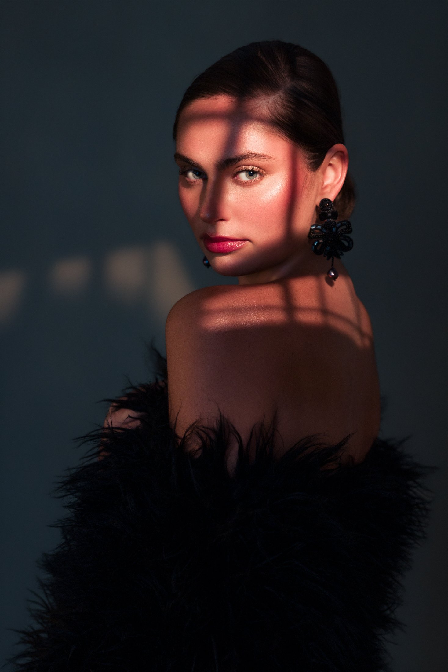 Isabel Crowe in vintage fur with hard gobo light across her face